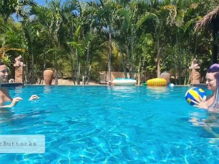 Naked teens play with a ball in the pool