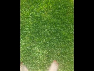 Sexy barefoot teen walks through grass 