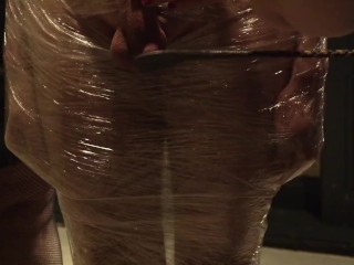 Male slave bound in cling wrap gets riding crop CBT by two gorgeous Femdoms