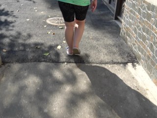 BBW in flip flops walks along the sidewalk while a voyeur peeps on her feet Public foot fetish