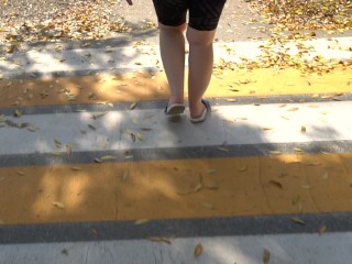 BBW in flip flops walks along the sidewalk while a voyeur peeps on her feet Public foot fetish