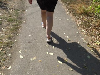 BBW in flip flops walks along the sidewalk while a voyeur peeps on her feet Public foot fetish