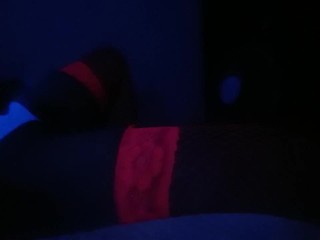 Crossdresser streaptease under UV light 