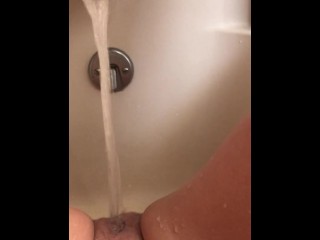 Horny hot thick MILF wiggles hips and uses bath tub faucet to get off in bathtub