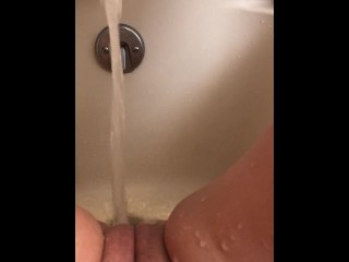 Horny hot thick MILF wiggles hips and uses bath tub faucet to get off in bathtub