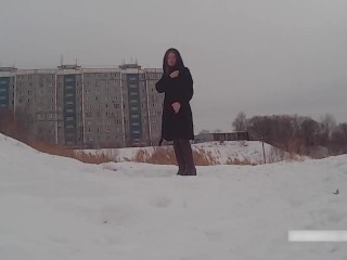 Winter street photoshoot in a fur coat on a naked body