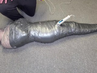 Harley Quinn wrapped in layers of mummification bondage then teased with a wand & made to cum