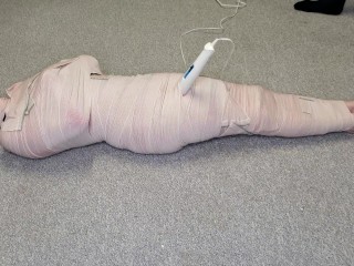 Harley Quinn wrapped in layers of mummification bondage then teased with a wand & made to cum