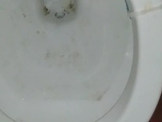 Peeing standing up in a dirty toilet