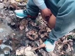 teen pissing in a forest stream after a run