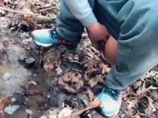 teen pissing in a forest stream after a run