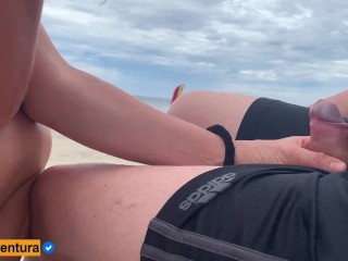 She loves to make a handjob on the crowded beach