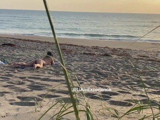 Spying hot MILF touching at the beach