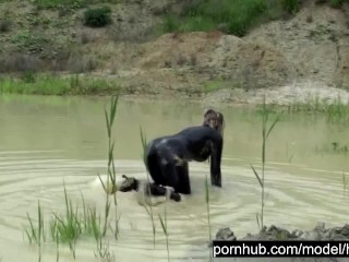 Blond Girl In Black Rubber Catsuit Bathes In The Mud And Rips Her Latex Catsuit