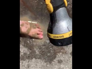 Cleaning my muddy feet with hose