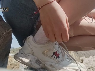 Walking on the beach with a plug in my ass and bare tits, masturbating on the rocks near people