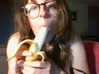 girl with cute glasses sucks banana