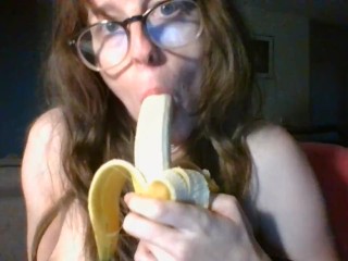 girl with cute glasses sucks banana