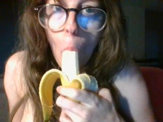 girl with cute glasses sucks banana