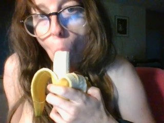 girl with cute glasses sucks banana