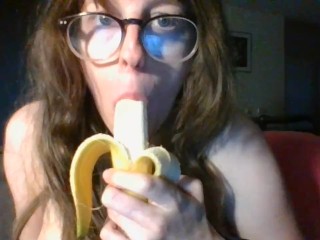 girl with cute glasses sucks banana