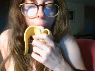 girl with cute glasses sucks banana