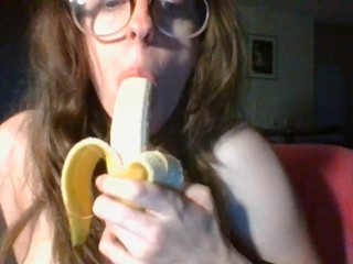 girl with cute glasses sucks banana