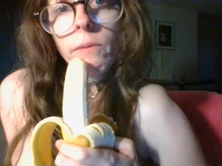 girl with cute glasses sucks banana