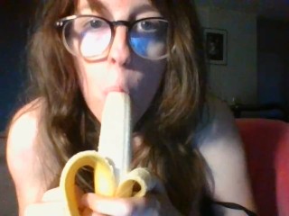 girl with cute glasses sucks banana