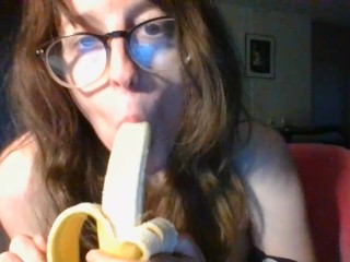 girl with cute glasses sucks banana