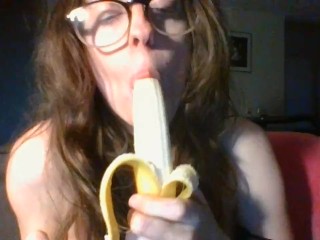 girl with cute glasses sucks banana