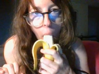 girl with cute glasses sucks banana