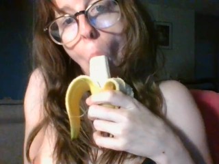 girl with cute glasses sucks banana