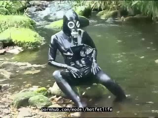 Outdoor walk in the wood and river bath full encased in black latex catsuit and rubber gas mask