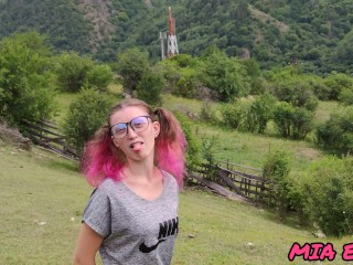 beauty with pink tips walks in nature in the mountains attracting attention to herself