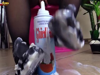 Brunette in pantyhose gives footjob to a cream tube