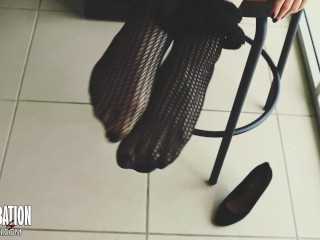 Shoe dangling with fishnets and black high heels
