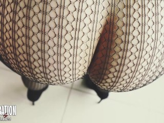 Shoe dangling with fishnets and black high heels