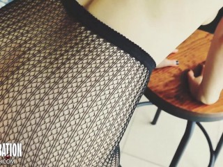 Shoe dangling with fishnets and black high heels