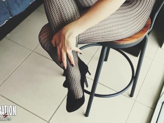 Shoe dangling with fishnets and black high heels