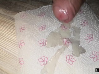 I play with a big cock and cum on a napkin. Close-up.