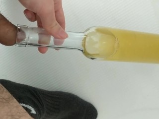 Filling up a wine bottle with piss