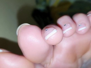 French Pedicured feet and wrinkled soles close up