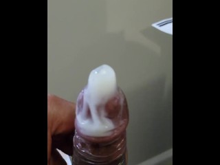 Jacking off moaning busting a hard nut in a condom