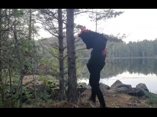 Fursuiter taking a piss against a tree