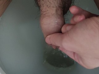 Holding piss in foreskin and letting it go