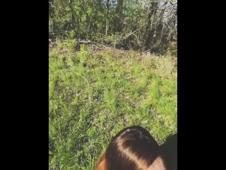 Submissive girl deepthroating in an open field next to a country road