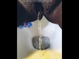 Ebony wife peeing a golden stream