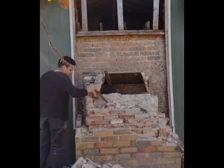 Demolishing a brick chimney