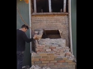 Demolishing a brick chimney